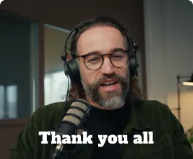 Bearded man wearing glasses and headphones speaking into a microphone with 'Thank you all' text at the bottom.